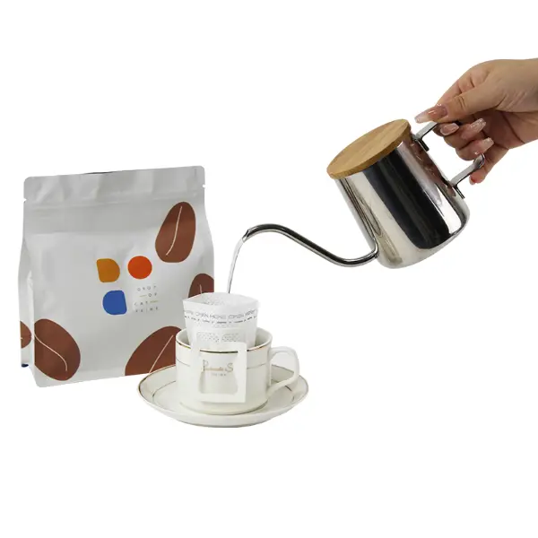 Hand pouring hot water over drip coffee filter